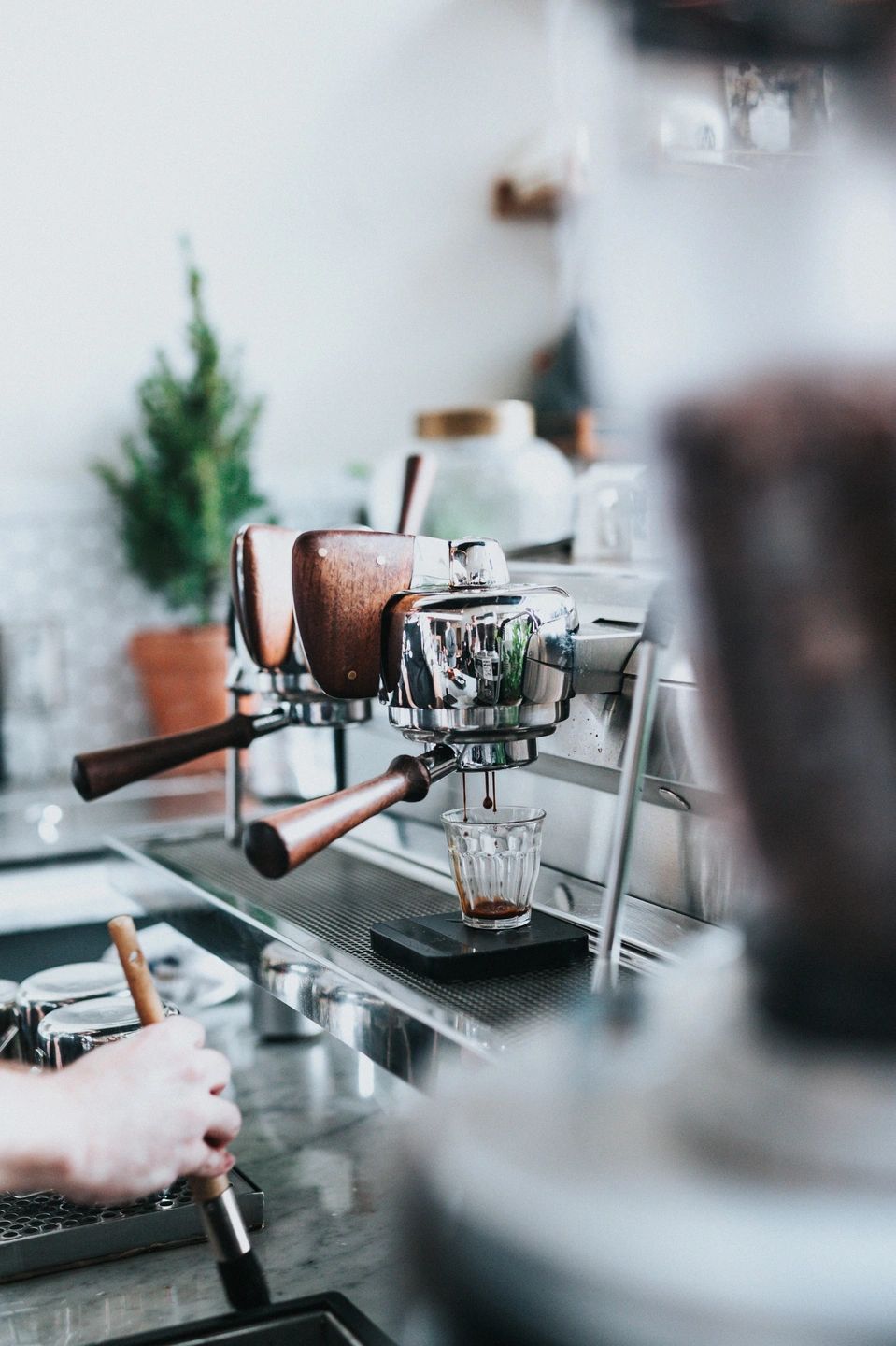 Barista operating espresso machine