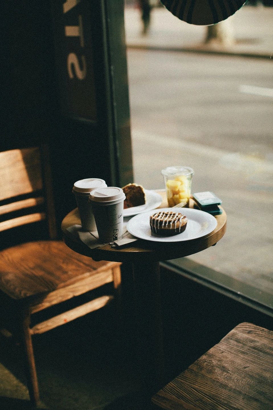 Outdoor café table with pastries and coffee